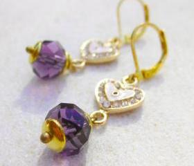 Earrings with rhinestone heart evil eye charms and purple crystals 